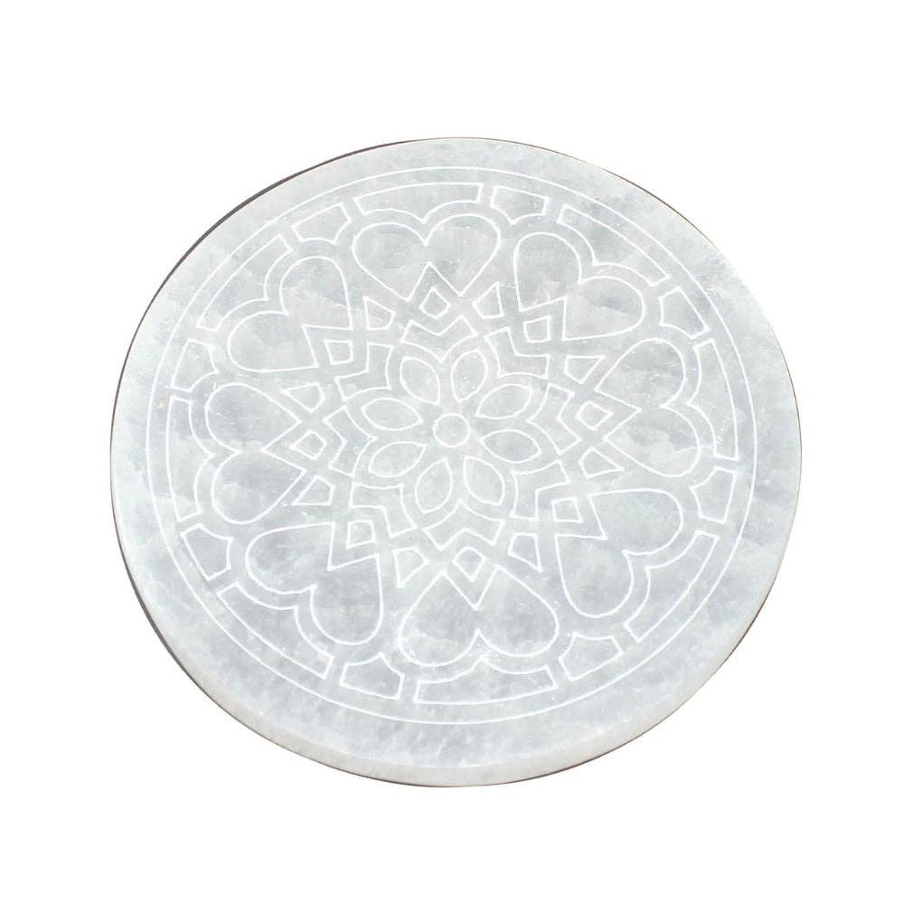 round selenite with rose flower design on white background