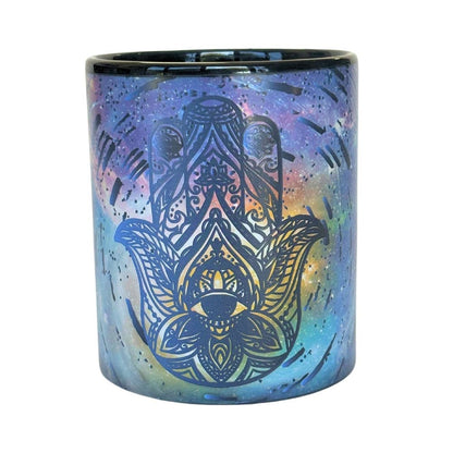 Colorful spiritual art mug with Hamsa hand design on a white background