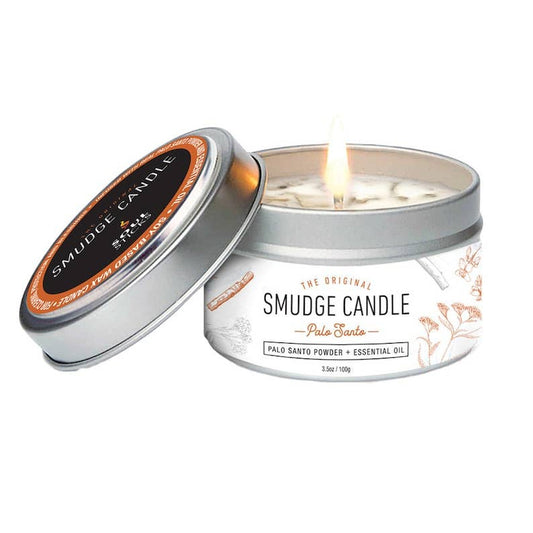 Palo Santo Smudge candle in a tin with a lit candle inside, on a white background