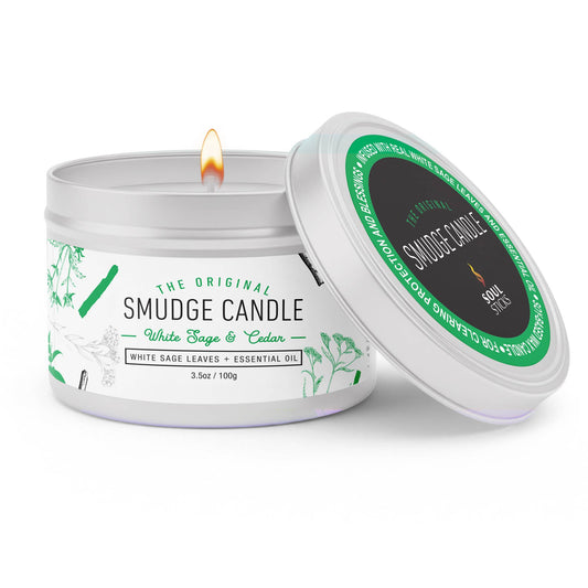 Smudge candle with white label and green accents on a white background