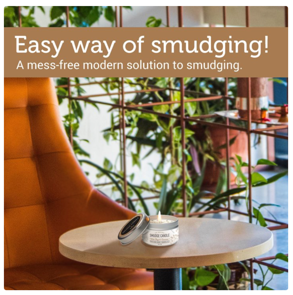 A small round tin candle sits on a light wood table in a modern indoor setting with an orange tufted chair, green plants, and a metal grid structure in the background. A brown banner at the top reads, 'Easy way of smudging! A mess-free modern solution to smudging.